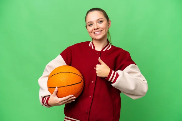 若いですブロンド女性プレイバスケットボール上の隔離されたクロマキーバック与えますA親指アップジェスチャー — ストック写真