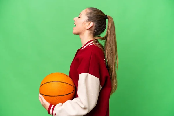 若いですブロンド女性プレイバスケットボール上の隔離されたクロマキー背景笑いますで横位置 — ストック写真
