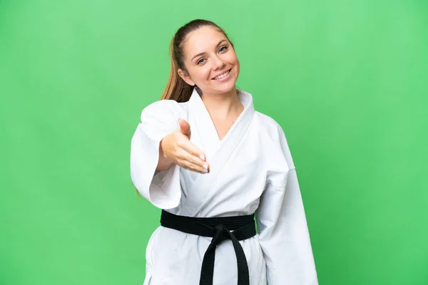 stock image Young blonde woman doing karate over isolated chroma key background shaking hands for closing a good deal