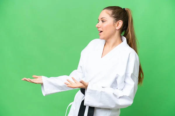 stock image Young blonde woman doing karate over isolated chroma key background with surprise expression while looking side