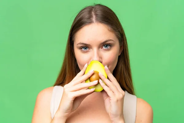 Young Blonde Woman Isolated Chroma Key Background Holding Avocado Close — Stock Photo, Image