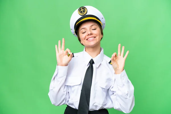 stock image Airplane pilot woman over isolated chroma key background in zen pose