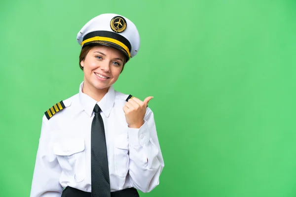 stock image Airplane pilot woman over isolated chroma key background pointing to the side to present a product