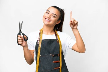 Seamstress woman over isolated white background pointing up a great idea