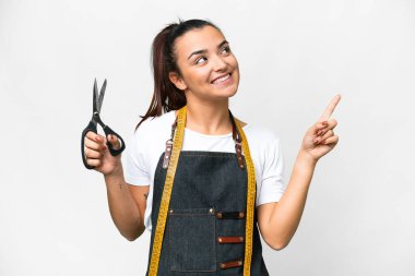 Seamstress woman over isolated white background pointing up a great idea