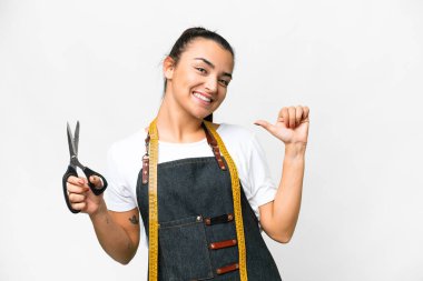 Seamstress woman over isolated white background proud and self-satisfied