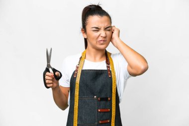 Seamstress woman over isolated white background frustrated and covering ears