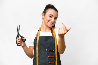 Seamstress woman over isolated white background inviting to come with hand. Happy that you came