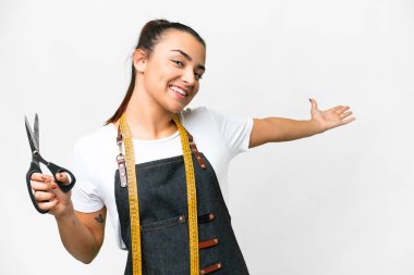 Seamstress woman over isolated white background extending hands to the side for inviting to come