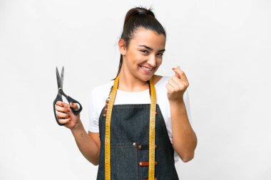 Seamstress woman over isolated white background making money gesture