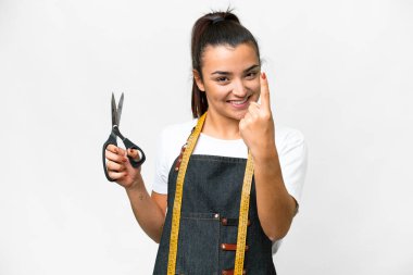 Seamstress woman over isolated white background doing coming gesture