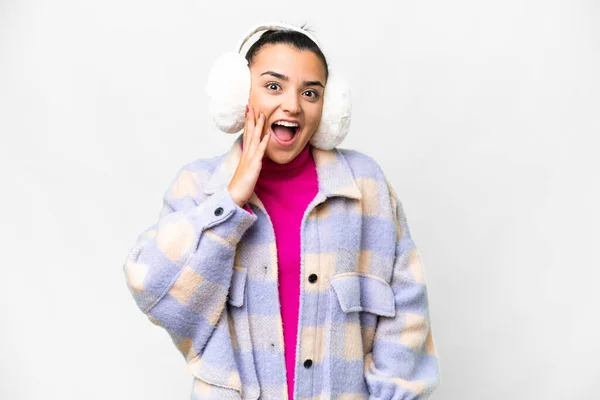 stock image Young woman wearing winter muffs over isolated white background with surprise and shocked facial expression