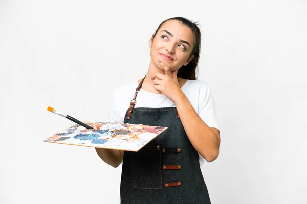 孤立した白い背景の上にパレットを持つ若いアーティストの女性は 笑顔を浮かべながら見上げる — ストック写真