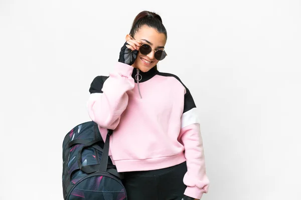 stock image Young sport woman with sport bag over isolated white background with glasses and happy