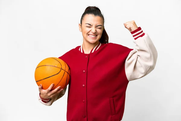 stock image Young Woman playing basketball over isolated white background doing strong gesture