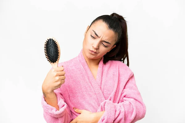 stock image Young woman in a bathrobe with hair comb over isolated white background with sad expression