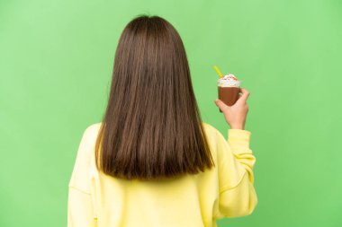 Arka planda izole edilmiş krom anahtar arka planda çikolata kremi olan küçük bir kız.