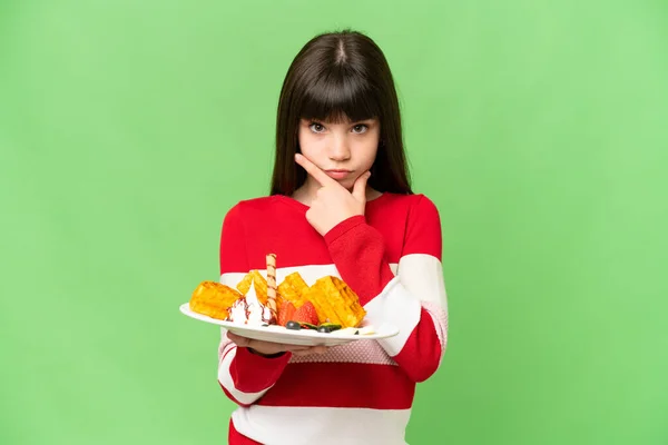 Little Girl Holding Waffles Isolated Chroma Key Background Thinking — Stock Photo, Image