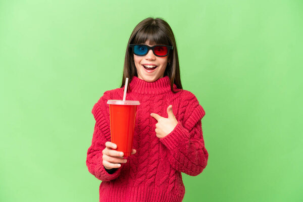 Little girl holding soda over isolated chroma key background with surprise facial expression