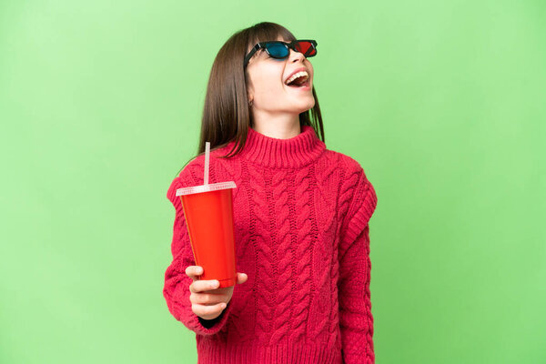 Little girl holding soda over isolated chroma key background laughing