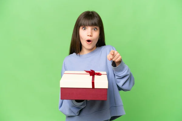Little Girl Holding Gift Isolated Chroma Key Background Surprised Pointing — Stock Photo, Image