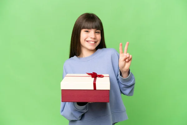 Kleines Mädchen Mit Einem Geschenk Über Isoliertem Chroma Schlüsselhintergrund Lächelt — Stockfoto