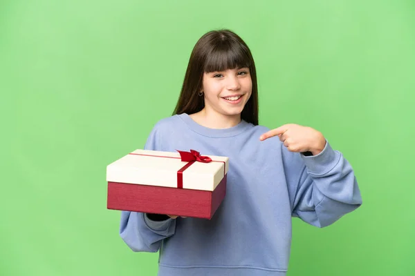 Little Girl Holding Gift Isolated Chroma Key Background Pointing — Stock Photo, Image