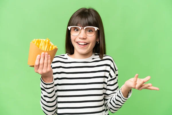 Little Girl Holding Fried Chips Isolated Chroma Key Background Shocked — Stock Photo, Image