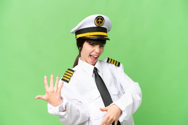 stock image Little girl as a Airplane pilot over isolated chroma key background making guitar gesture