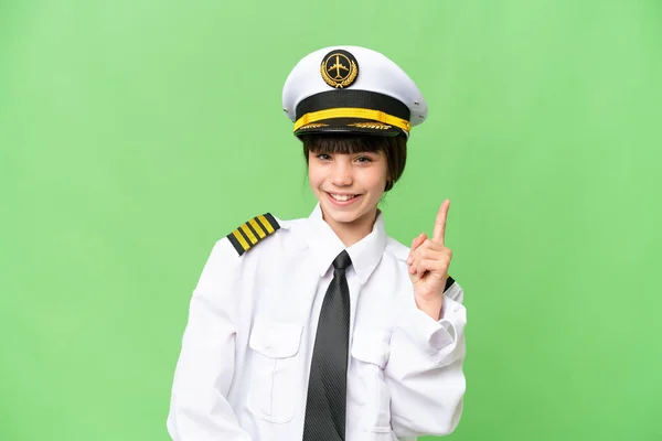 小女孩作为飞机驾驶员 在孤立的彩色关键背景下展示和举起一个手指 这标志着最好的 — 图库照片