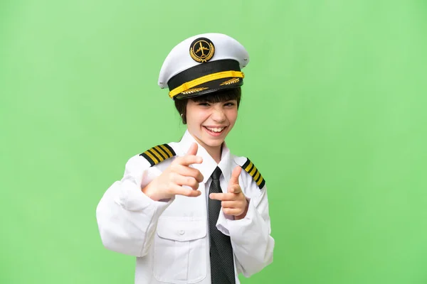 stock image Little girl as a Airplane pilot over isolated chroma key background pointing to the front and smiling