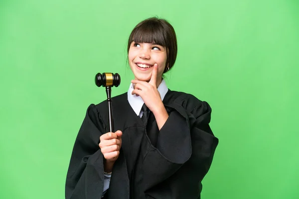 stock image Little girl playing as a Judge over isolated background thinking an idea while looking up