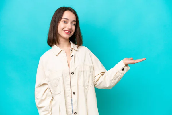 Young Ukrainian Woman Isolated Blue Background Extending Hands Side Inviting — 图库照片