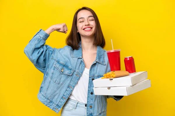 Young Ukrainian Woman Holding Fast Food Isolated Yellow Background Doing — Stock Photo, Image