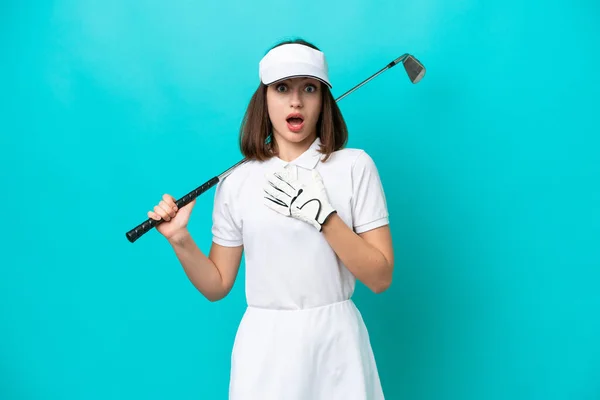 年轻的乌克兰高尔夫球手女人被蓝色背景隔离 看着右边 感到惊讶和震惊 — 图库照片