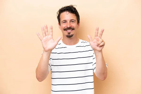 Young Caucasian Man Isolated Beige Background Counting Eight Fingers — Stockfoto
