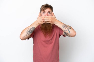 Redhead man with long beard isolated on white background covering mouth with hands