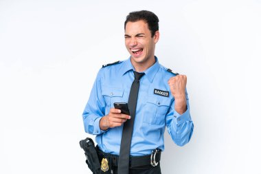 Young police caucasian man isolated on white background with phone in victory position