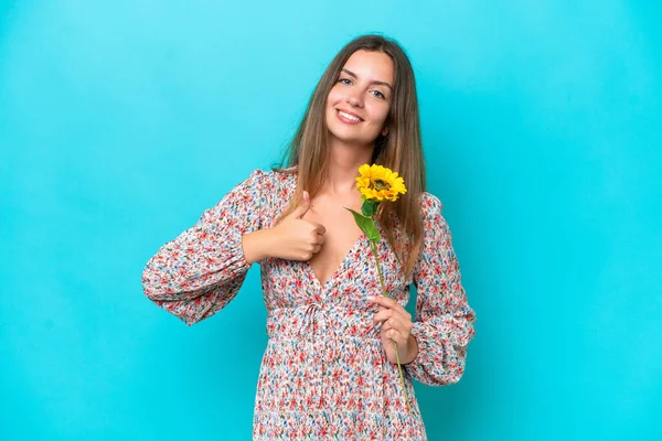 Young Caucasian Woman Holding Sunflower Isolated Blue Background Giving Thumbs — Stock Photo, Image