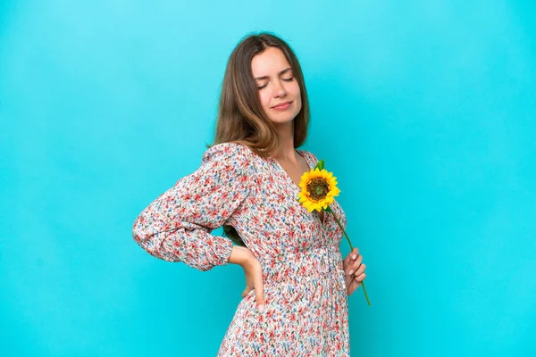 Young Caucasian Woman Holding Sunflower Isolated Blue Background Suffering Backache — Stock Photo, Image