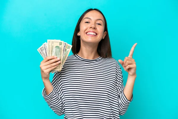 Young Caucasian Woman Taking Lot Money Isolated Blue Background Showing — Stock fotografie