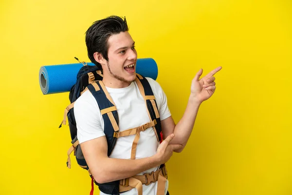 Junger Russischer Bergsteiger Mit Einem Großen Rucksack Auf Gelbem Hintergrund — Stockfoto