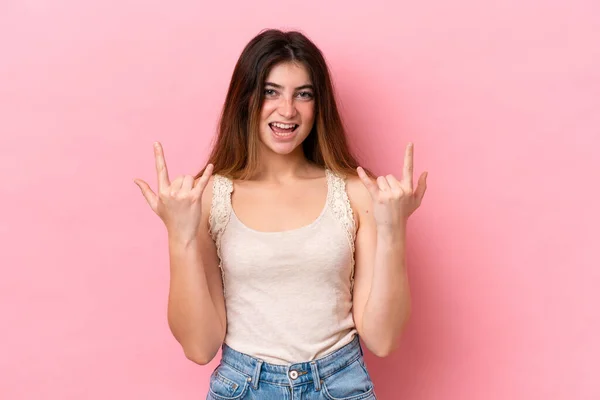 stock image Young caucasian woman isolated on pink background making horn gesture