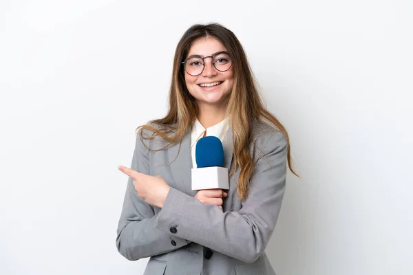 stock image Young caucasian TV presenter woman isolated on white background pointing to the side to present a product