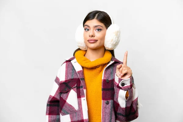 Young Russian woman wearing winter muffs over isolated white background pointing with the index finger a great idea