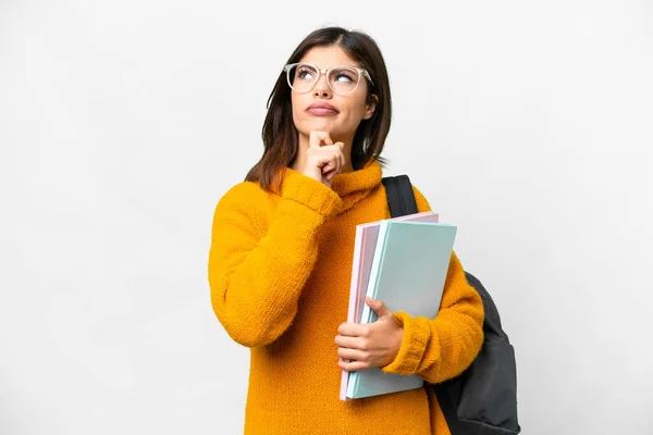 stock image Young student woman over isolated white background having doubts and thinking