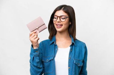 Young Russian woman holding a wallet over isolated white background with happy expression