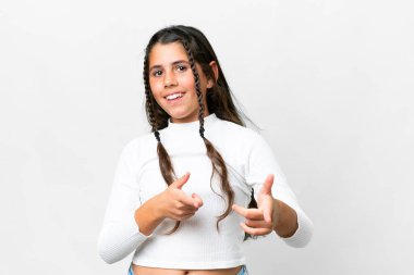 Young girl over isolated white background pointing to the front and smiling