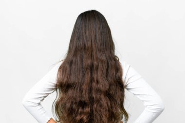 Young girl over isolated white background in back position