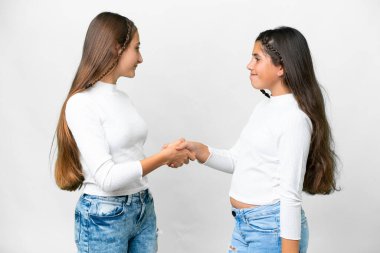 Friends girls over isolated white background handshaking after good deal